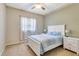 Comfortable bedroom with a white bed, blue accents, and a sunny window at 622 Pine Ranch East Rd, Osprey, FL 34229