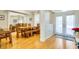 Formal dining room with hardwood floors, white pillars, and a view to the front entry at 622 Pine Ranch East Rd, Osprey, FL 34229