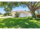 Charming single-story home featuring a well-manicured lawn, mature trees, and a large two-car garage at 622 Pine Ranch East Rd, Osprey, FL 34229