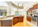 Kitchen with stainless steel appliances, granite countertops, and wood cabinets, open to the living room at 622 Pine Ranch East Rd, Osprey, FL 34229