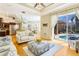 Bright living room with an open floor plan, comfortable seating, and access to the screened pool area at 622 Pine Ranch East Rd, Osprey, FL 34229
