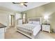 Bright main bedroom featuring neutral tones, carpet floors, and a ceiling fan at 622 Pine Ranch East Rd, Osprey, FL 34229