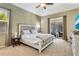 Comfortable main bedroom with a ceiling fan, carpeted floors, and slider doors to the pool at 622 Pine Ranch East Rd, Osprey, FL 34229