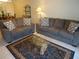 Cozy living room with comfortable sofas, a patterned rug, and an elegant glass-top coffee table at 649 Tamiami S Trl # 102, Venice, FL 34285
