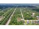 An aerial view circles the new home nestled within lush woods offering a secluded oasis at 66 Statler St, Port Charlotte, FL 33954