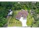 Aerial view highlighting the new home with a long driveway, spacious green yard, and utility shed at 66 Statler St, Port Charlotte, FL 33954