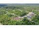 An aerial view circles the new home nestled within lush woods offering a secluded oasis at 66 Statler St, Port Charlotte, FL 33954