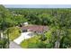 An aerial view of a home with a red roof surrounded by trees at 66 Statler St, Port Charlotte, FL 33954