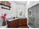 Well-lit bathroom with a shower, marble countertop, and dark wood cabinets at 66 Statler St, Port Charlotte, FL 33954