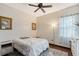 Well-lit bedroom with a bed, fan, window, and light colored dresser at 66 Statler St, Port Charlotte, FL 33954
