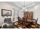 Dining room with hardwood floors, chandelier, dining table, and chairs at 66 Statler St, Port Charlotte, FL 33954