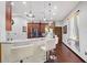 An open kitchen bar area featuring white stools, white cabinets, and granite countertops at 66 Statler St, Port Charlotte, FL 33954