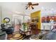 Open living room with hardwood floors, a television, and views into other living areas at 66 Statler St, Port Charlotte, FL 33954