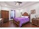 Comfortable main bedroom with wood floors, fan, window, and wood furniture at 66 Statler St, Port Charlotte, FL 33954