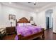Comfortable main bedroom with wood floors, tray ceiling, and wood furniture at 66 Statler St, Port Charlotte, FL 33954