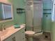 Bathroom featuring white vanity with sink and storage, glass shower stall, and soft teal colored walls at 6741 Laurel Ct, North Port, FL 34287