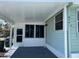 This home features an enclosed carport area with access door, screened windows, and light green exterior siding at 6741 Laurel Ct, North Port, FL 34287