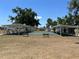 Community shuffleboard courts with benches and covered areas, set against a backdrop of green spaces and trees at 6741 Laurel Ct, North Port, FL 34287