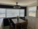 Bright dining room featuring a wooden table, modern light fixture, and large windows with plenty of natural light at 6741 Laurel Ct, North Port, FL 34287