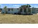 Home featuring vibrant landscaping and a central air conditioning system at 6741 Laurel Ct, North Port, FL 34287