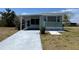 Charming single-story home with a covered patio and a well-maintained lawn at 6741 Laurel Ct, North Port, FL 34287