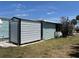 Side view of home with shed, offering extra storage and functionality at 6741 Laurel Ct, North Port, FL 34287