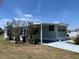 Well-maintained home featuring a covered carport and mature landscaping at 6741 Laurel Ct, North Port, FL 34287