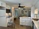 Open-concept kitchen featuring white cabinets, marble countertops, modern appliances, and a view into the living area at 6741 Laurel Ct, North Port, FL 34287