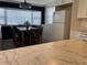This kitchen features marble counters, a black accent wall, a dining table with chairs, and an appliance garage at 6741 Laurel Ct, North Port, FL 34287
