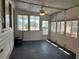 Enclosed porch with neutral paint, multiple windows, tiled floor, and access steps at 6741 Laurel Ct, North Port, FL 34287