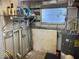 Utility room with shelving, hot water heater and plumbing at 6741 Laurel Ct, North Port, FL 34287