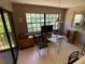 Cozy breakfast nook with a large window and a glass table set for two at 7560 Fairway Woods Dr # 305, Sarasota, FL 34238