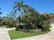 Well-manicured lawn and lush landscaping frame this charming single-Gathering home with a red-tile roof, adding to its curb appeal at 7560 Fairway Woods Dr # 305, Sarasota, FL 34238