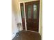 Elegant wooden front door with decorative glass panels and complementary sidelight, tiled entryway at 7560 Fairway Woods Dr # 305, Sarasota, FL 34238