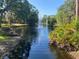 Picturesque water view showcasing pond with fountains surrounded by mature trees and lush foliage at 7560 Fairway Woods Dr # 305, Sarasota, FL 34238
