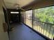 Relaxing screened porch with tile flooring and tranquil views of the surrounding greenery at 7560 Fairway Woods Dr # 305, Sarasota, FL 34238