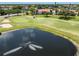 Panoramic aerial view showcases the property's golf course, pond with fountain and meticulously landscaped grounds at 770 Village Cir # 232, Venice, FL 34292