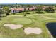 Golf course view with sand traps and water hazards next to condo buildings and landscaping at 770 Village Cir # 232, Venice, FL 34292
