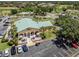 Aerial view of the clubhouse with outdoor seating and ample parking at 770 Village Cir # 232, Venice, FL 34292