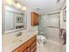 Bathroom featuring a tiled shower with a glass door, and a large mirror at 770 Village Cir # 232, Venice, FL 34292