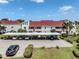 Condominium complex with multiple units, carports, and well-manicured lawns at 770 Village Cir # 232, Venice, FL 34292