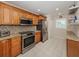 Well-lit kitchen boasts stainless appliances, granite counters, and ample cabinet space at 770 Village Cir # 232, Venice, FL 34292