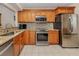 Modern kitchen with stainless steel appliances, granite counters, and tiled backsplash at 770 Village Cir # 232, Venice, FL 34292