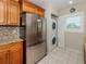 Bright kitchen boasts stainless steel appliances and in-unit washer/dryer at 770 Village Cir # 232, Venice, FL 34292