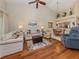 Open living space with wood floors and views into the dining and kitchen areas at 770 Village Cir # 232, Venice, FL 34292