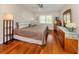 Relaxing main bedroom features a large window for natural light and hardwood floors at 770 Village Cir # 232, Venice, FL 34292