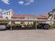 Covered parking area with assigned parking spaces and landscaping at 770 Village Cir # 232, Venice, FL 34292