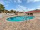 A sparkling community pool with patio furniture provides residents a space for outdoor enjoyment at 770 Village Cir # 232, Venice, FL 34292