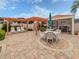 Pool area with patio furniture, pergola, table and chairs, grill and restrooms at 770 Village Cir # 232, Venice, FL 34292