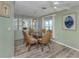 Dining room with a glass table, wicker chairs, built-in cabinets, and luxury vinyl flooring at 798 Fairmount Dr, North Port, FL 34287